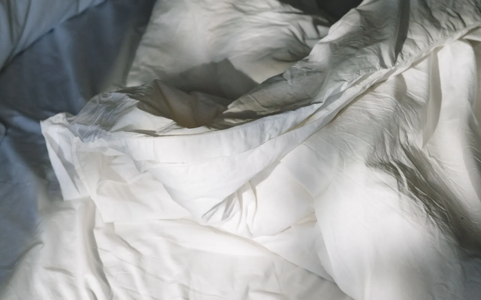Soft bedding in a naturally lit bedroom