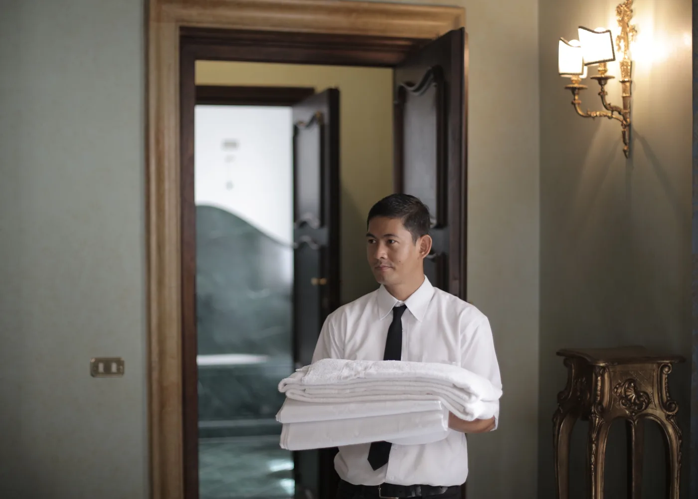 Hospitality staff handling hotel linen