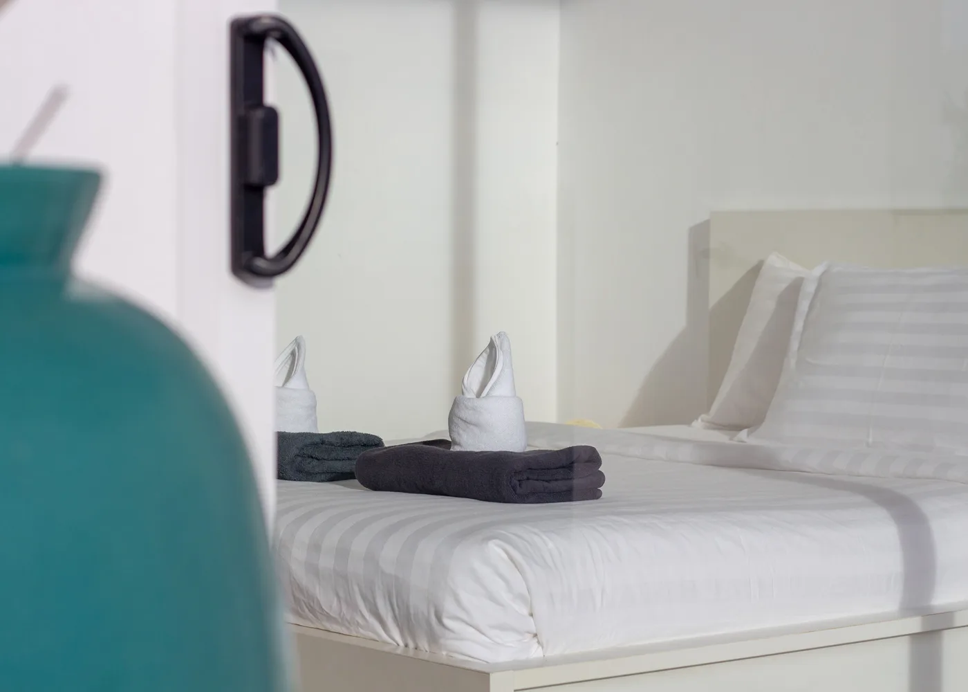 Hospitality guest room with prepared bed and towels