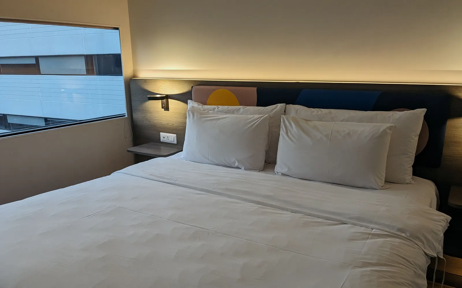 Modern hotel room prepared with white bed linen